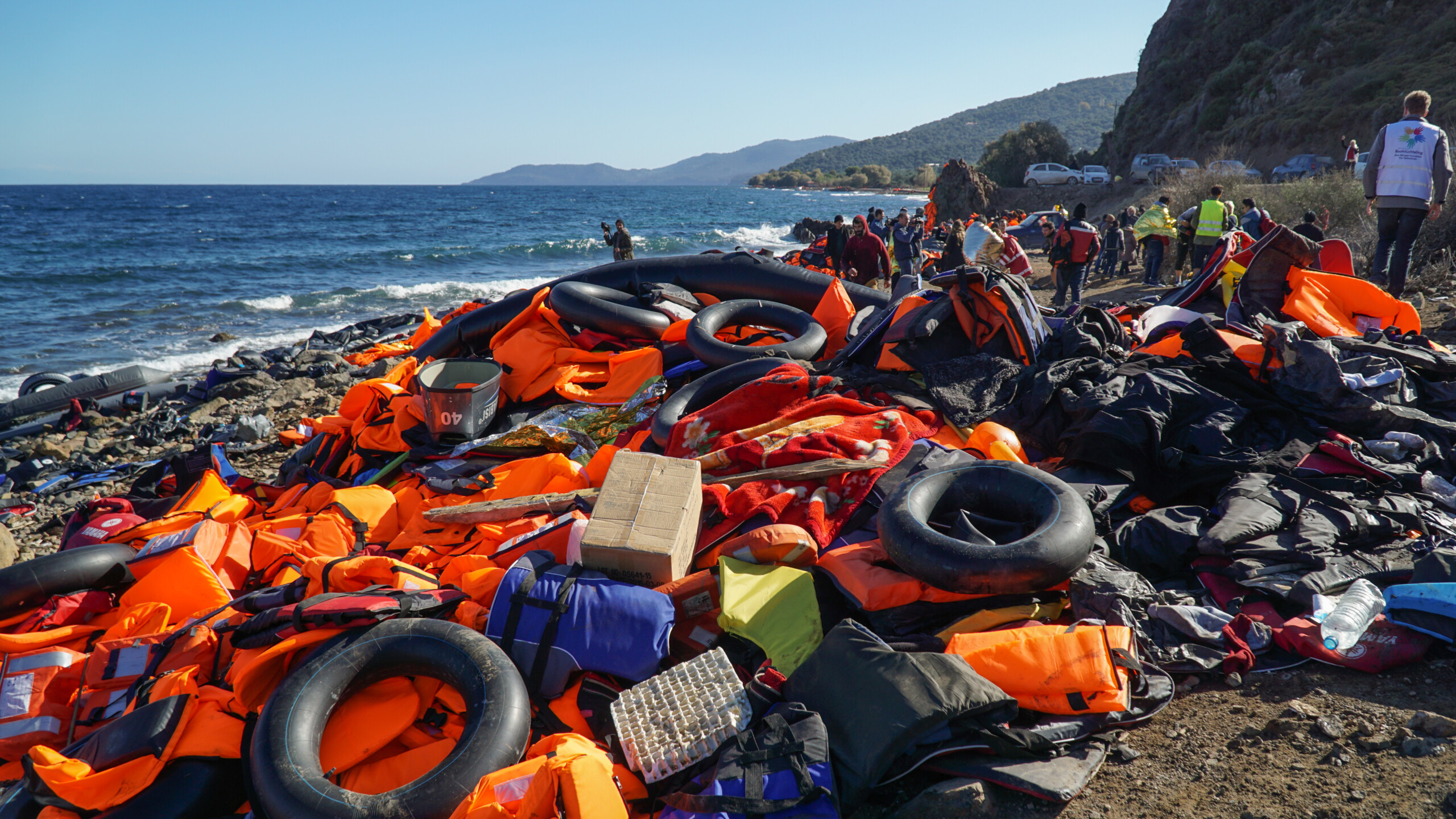 Refugees just arrived from Turkey on the boat to the shore of the Greek island of Lesbos. Abandoned belongings and life jackets on the shore of the island of Lesbos, which was previously used by the refugees. November 2015